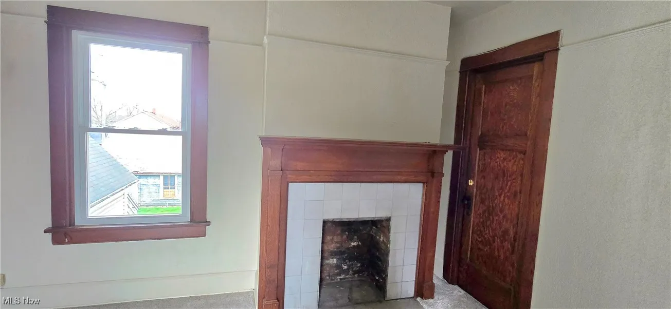 Interior details featuring a tile fireplace