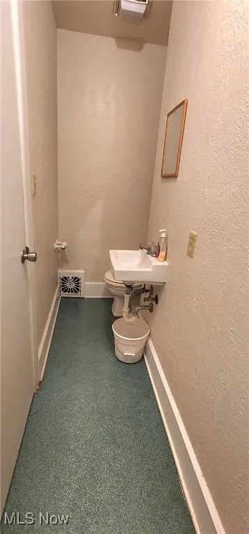 Bathroom featuring sink and toilet