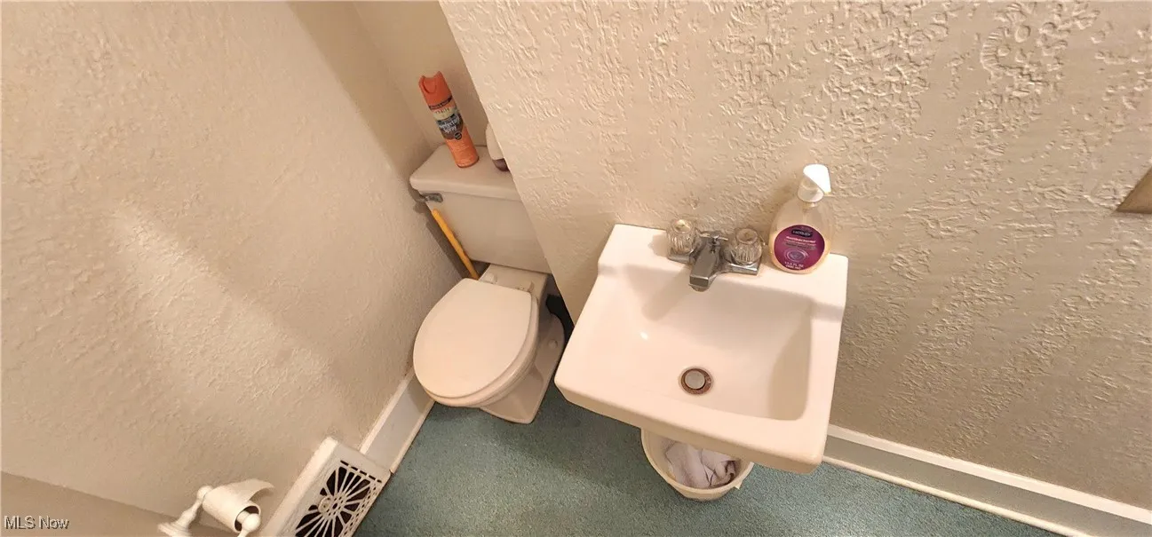 Bathroom featuring sink and toilet