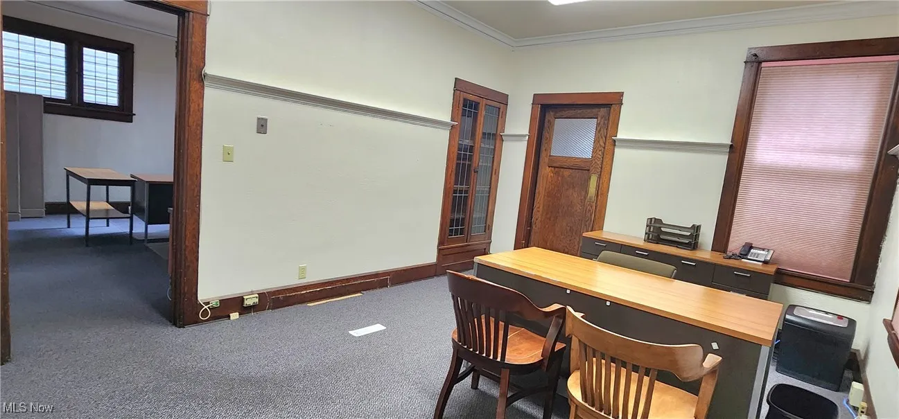 Carpeted office with ornamental molding