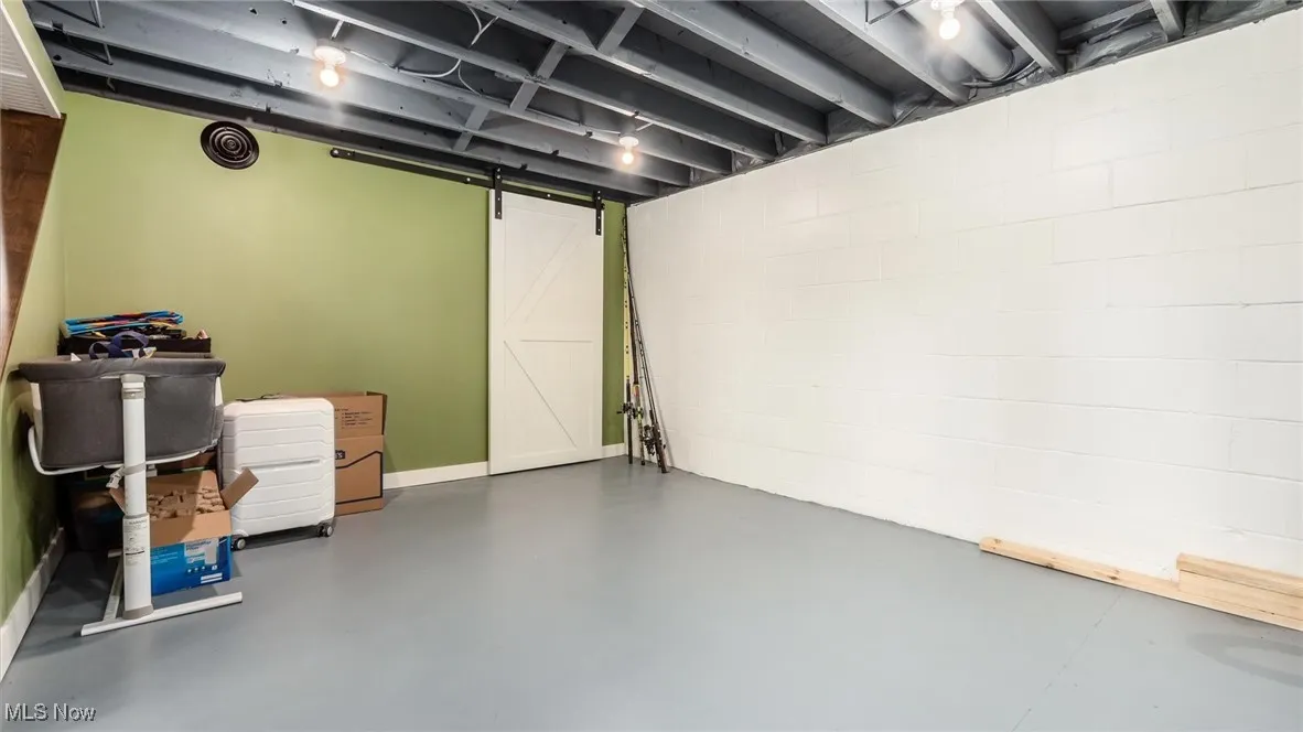 Finished below grade area featuring a barn door