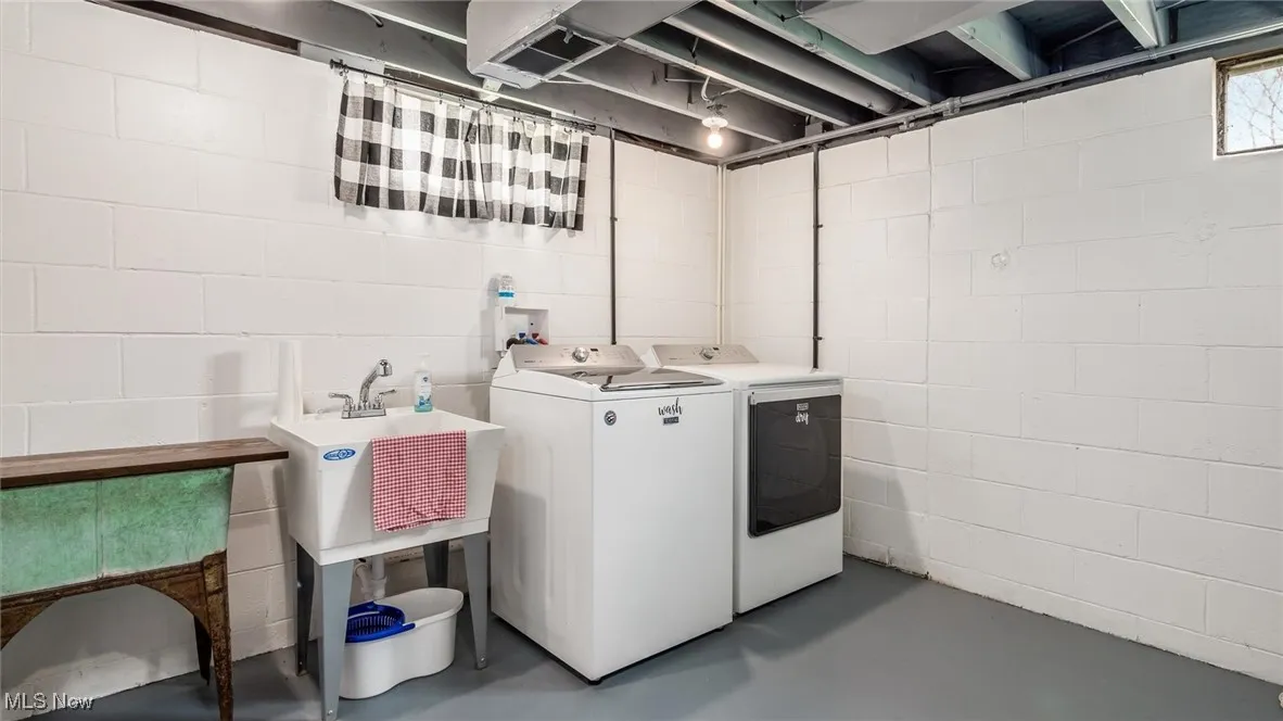 Laundry area with laundry area, a sink, and washing machine and dryer
