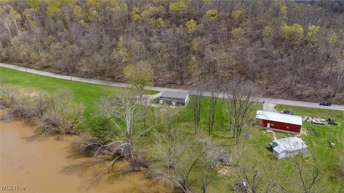 Birds eye view of property featuring a view of trees