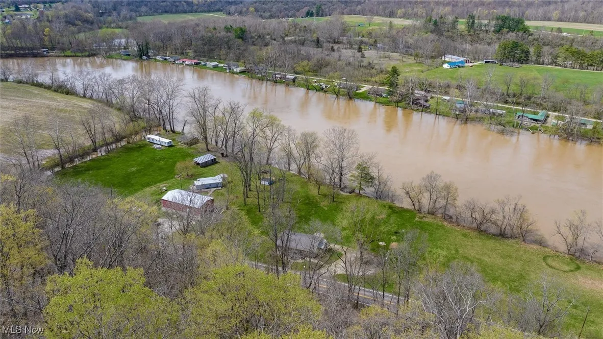 Birds eye view of property with a water view