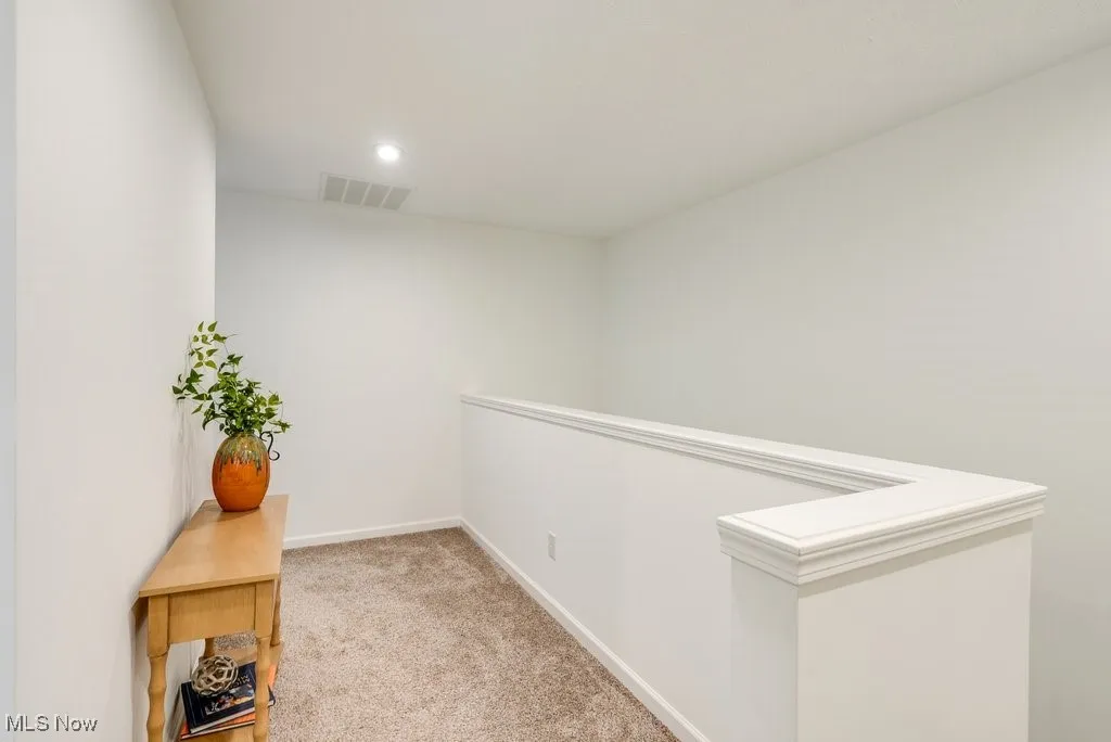 Up the stairs, this inviting pass-through corridor offers a versatile space that can be tailored to fit your lifestyle. With plenty of room for a bench, a low bookcase, or perhaps a collection of personal touches, this area serves as a seamless transition. It thoughtfully separates the primary bedroom suite from the other bedrooms, offering privacy and flow within the home.
