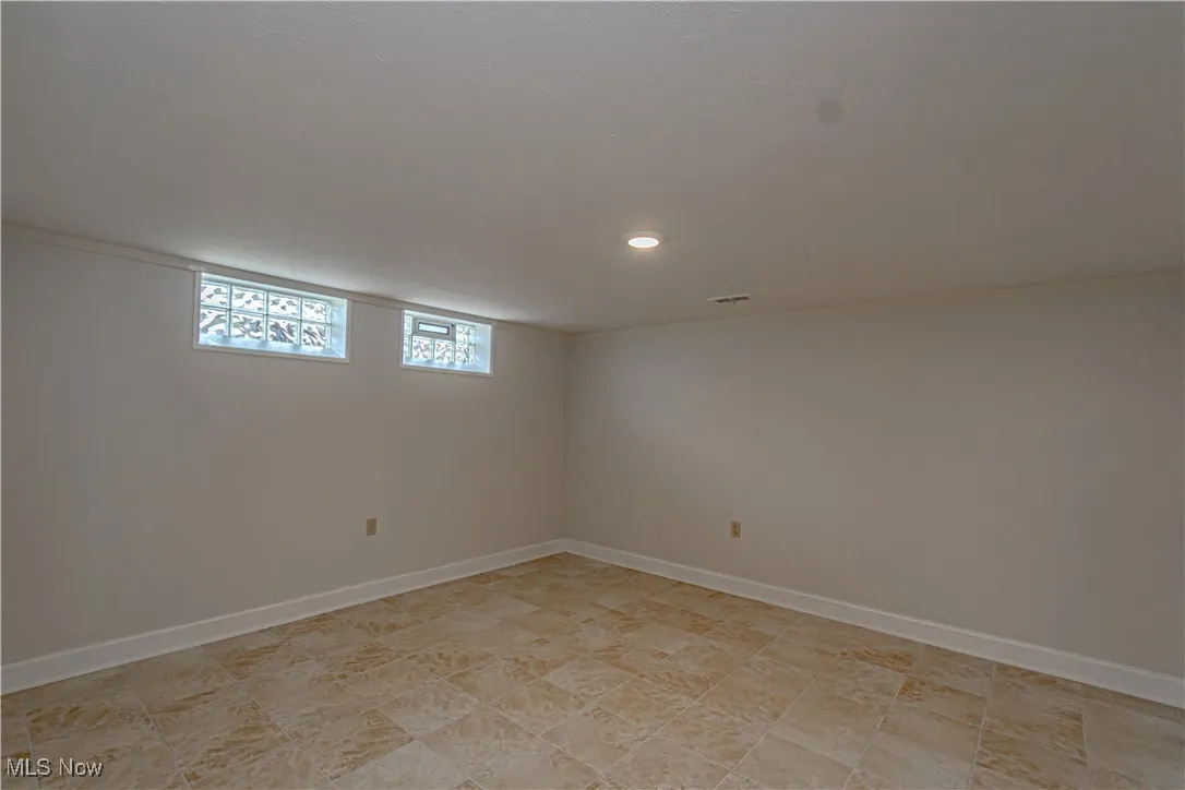 Below grade area featuring visible vents, baseboards, and recessed lighting