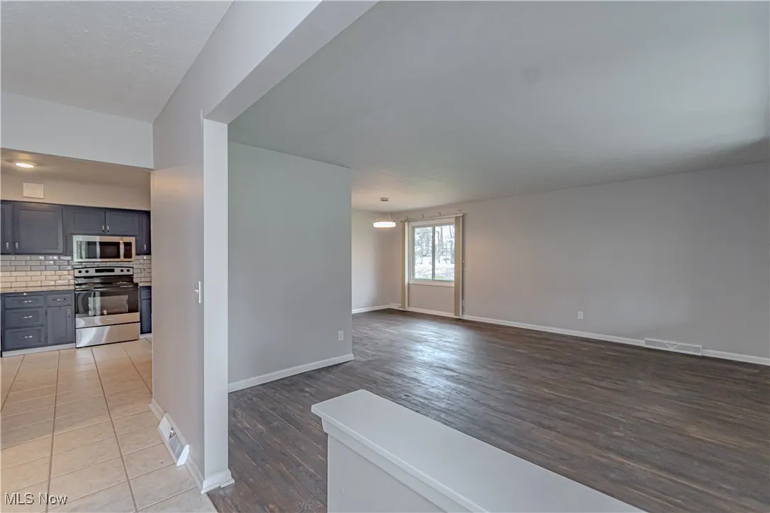 Spare room featuring visible vents, baseboards, and light wood-style flooring