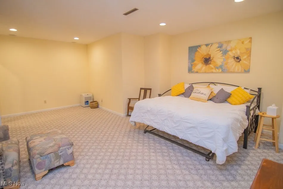 Carpeted bedroom with baseboards, visible vents, and recessed lighting
