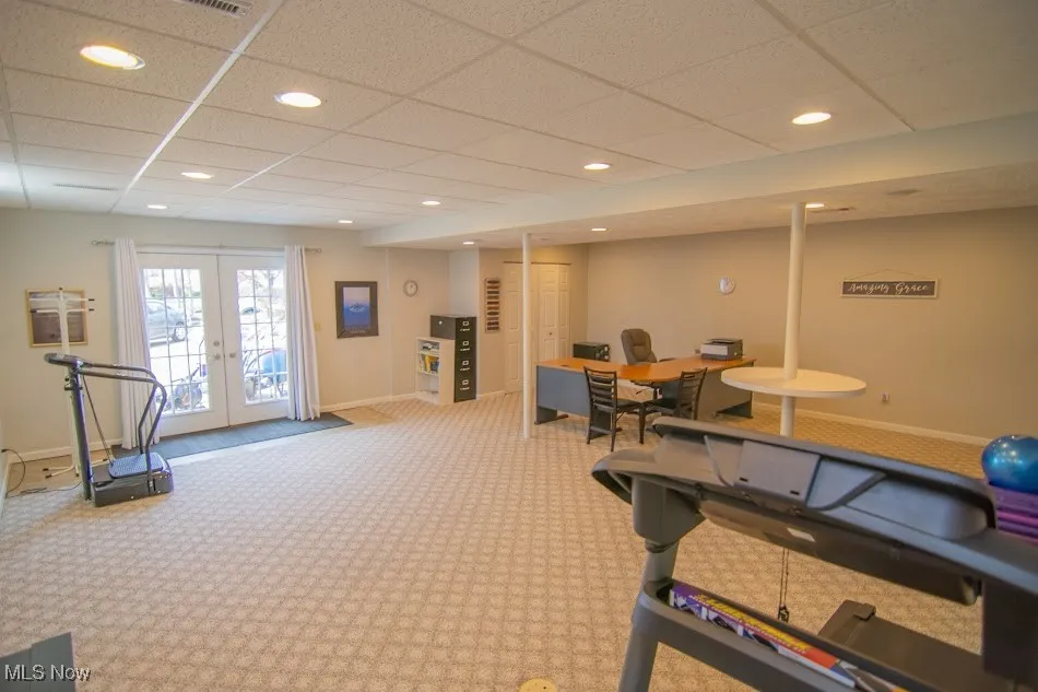 Exercise area featuring baseboards, recessed lighting, carpet flooring, french doors, and a drop ceiling