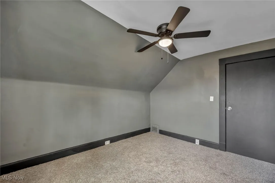 Bonus room with visible vents, a ceiling fan, carpet, and lofted ceiling