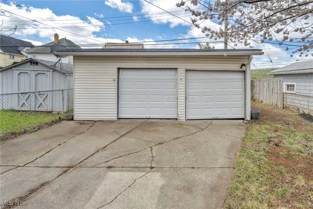 Detached garage featuring fence