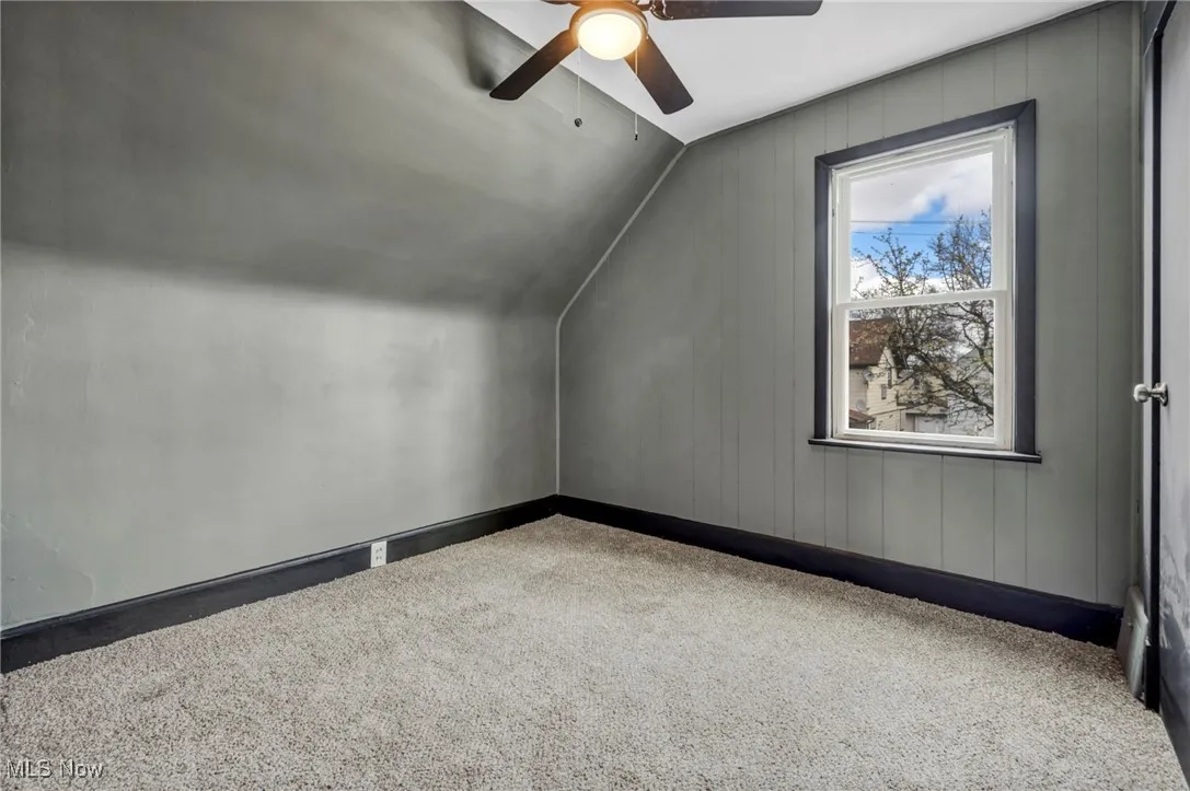 Bonus room with baseboards, a ceiling fan, lofted ceiling, and carpet floors