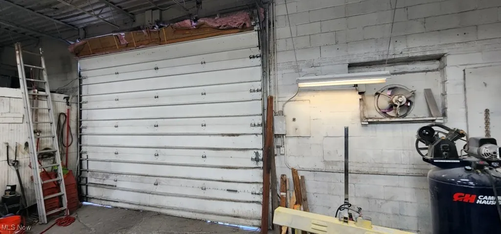 Garage featuring concrete block wall