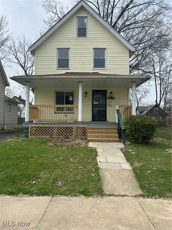 View of front facade featuring a porch and a front lawn