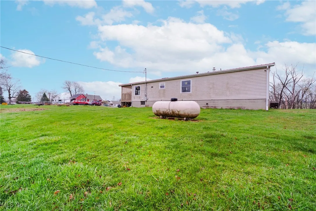 Back of property featuring a yard and crawl space