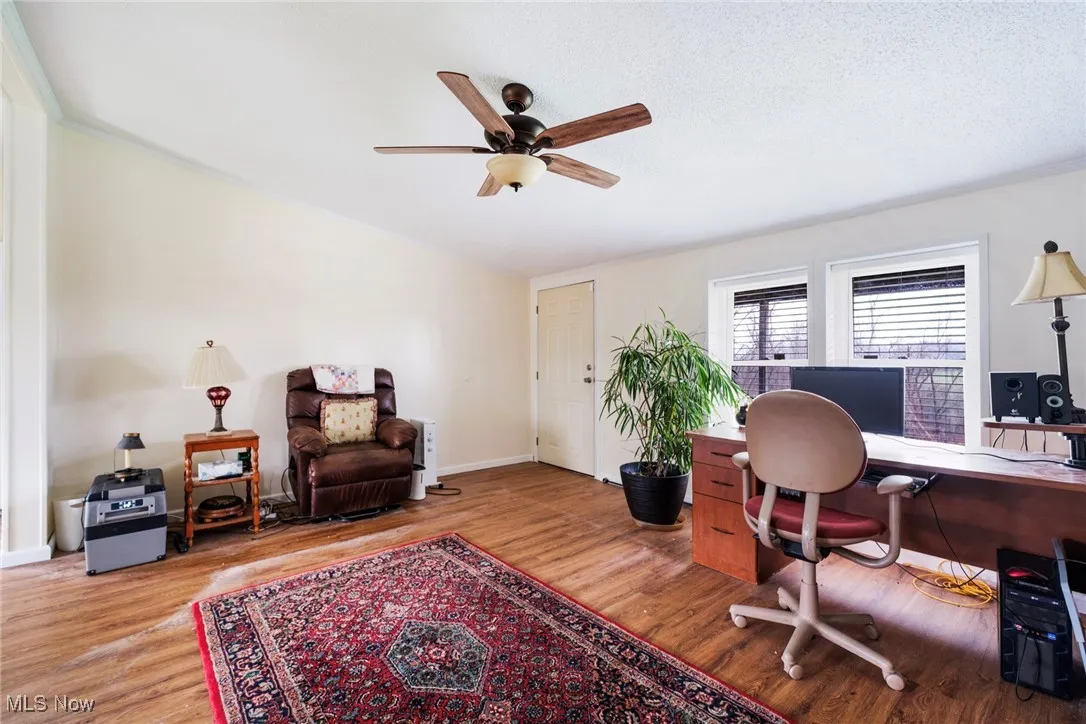 Office with baseboards, wood finished floors, and ceiling fan