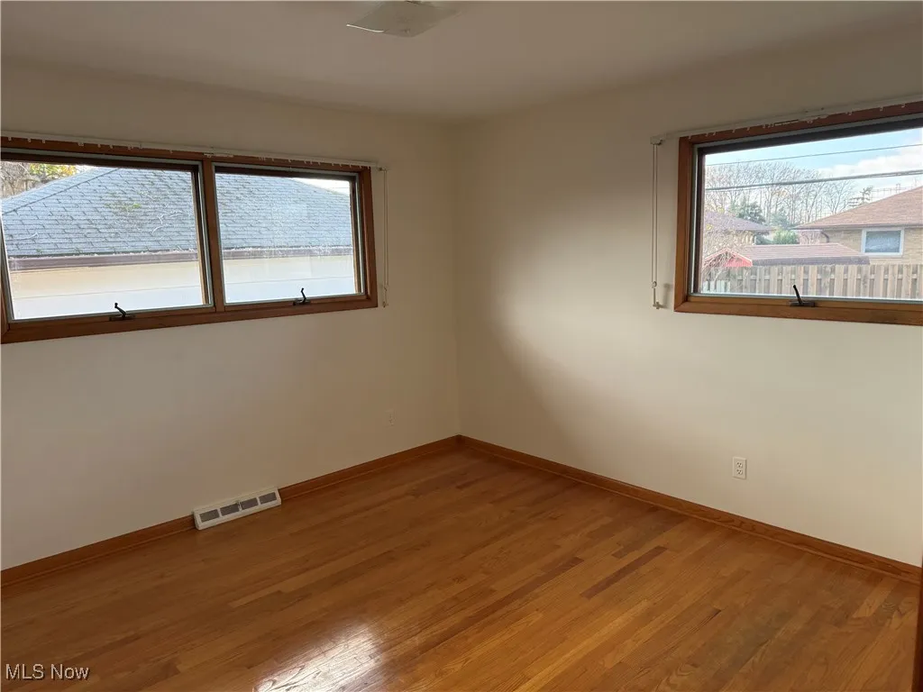 Bedroom with hardwood / wood-style flooring and a wealth of natural light