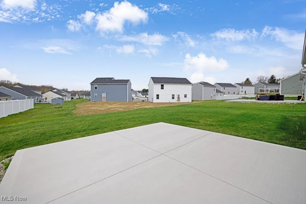 View of yard with a patio, fence, and a residential view