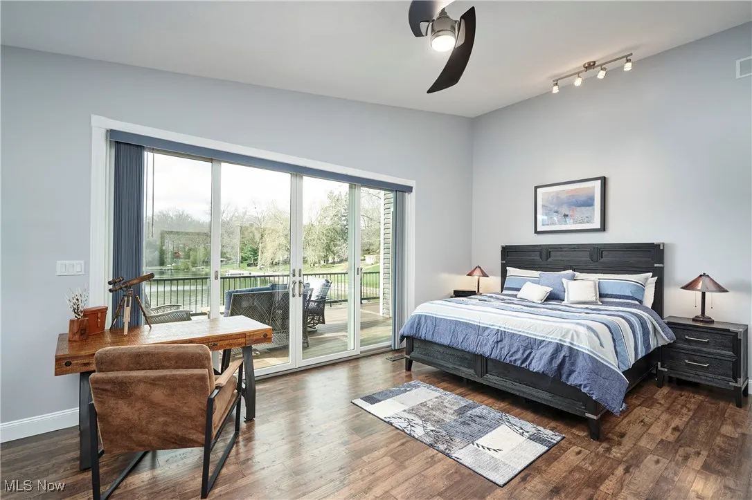 Bedroom with visible vents, multiple windows, access to outside, and wood finished floors