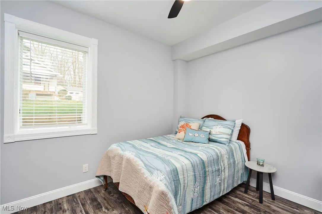 Bedroom with baseboards, a ceiling fan, and wood finished floors