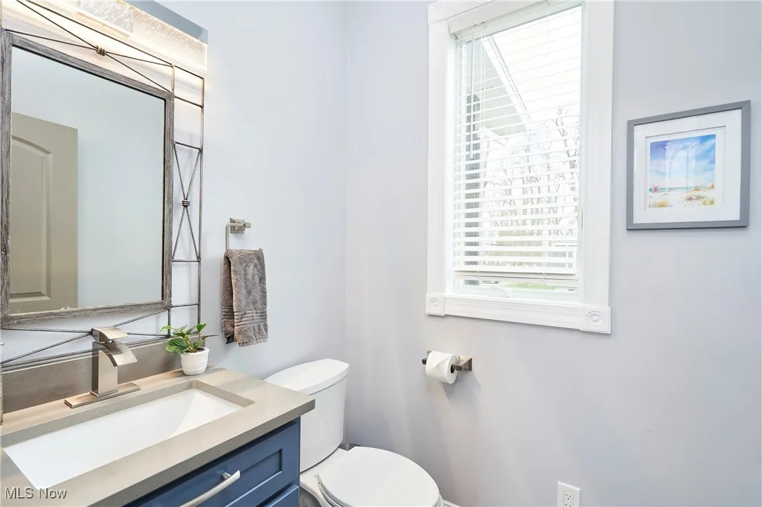 Main level Half Bathroom with toilet and vanity