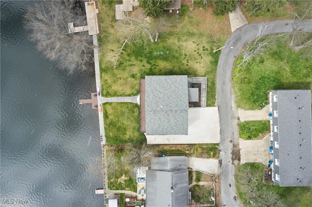 Birds eye view of property with a water view