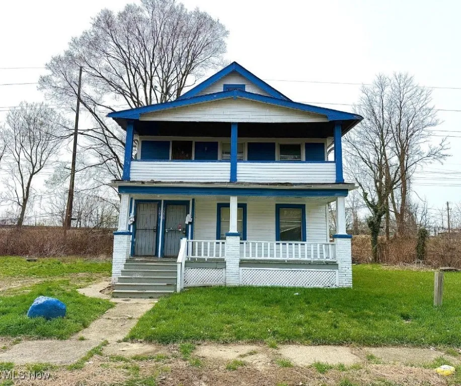 View of front of house with a front yard and covered porch