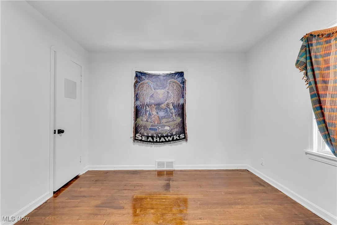 Empty room with wood finished floors and baseboards