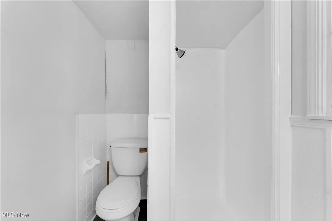 Bathroom with tile walls and a shower