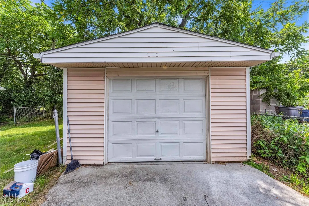 Detached garage featuring concrete driveway