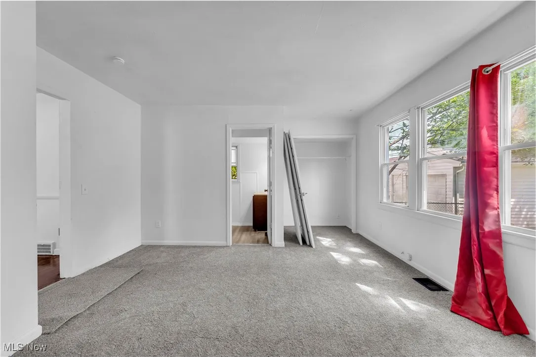 Unfurnished room with carpet floors and baseboards