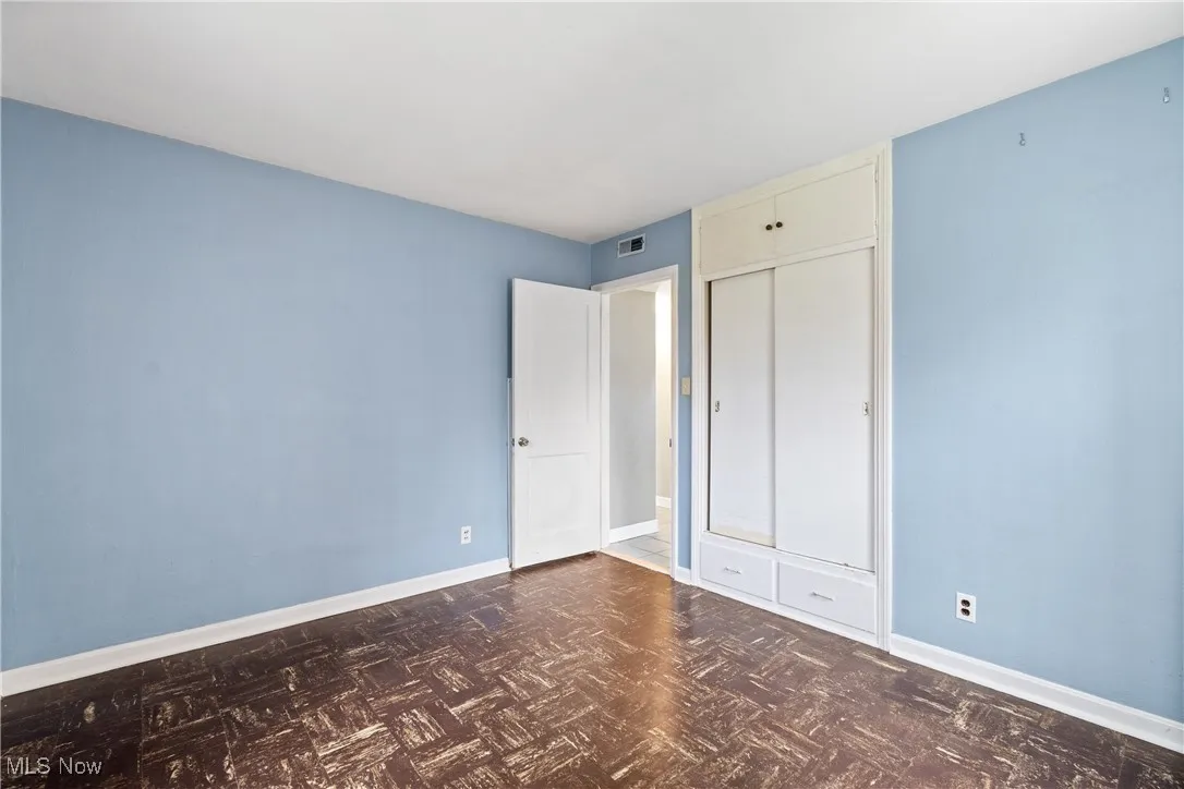Unfurnished bedroom featuring a closet, visible vents, and baseboards