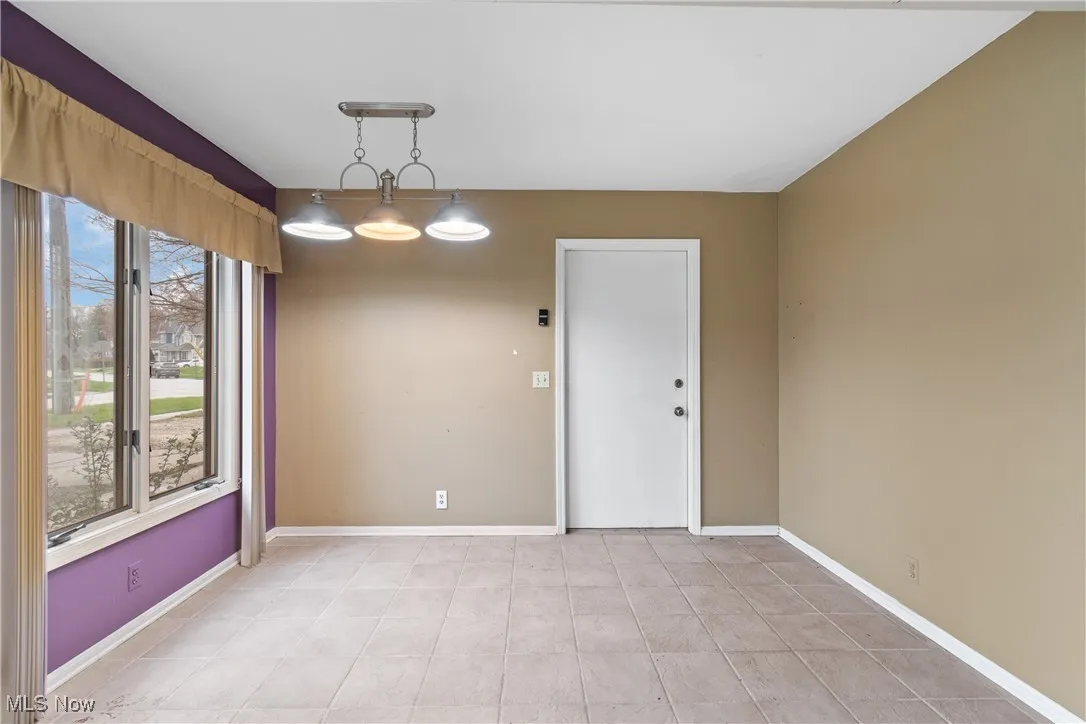 Unfurnished room featuring baseboards