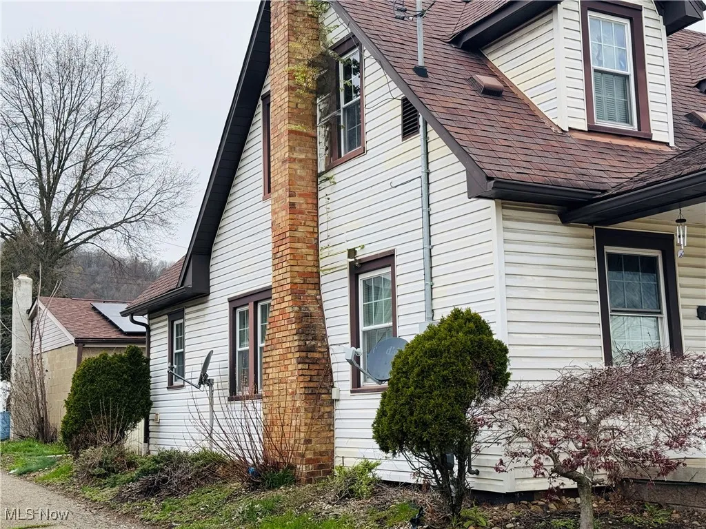 View of home's exterior with a chimney