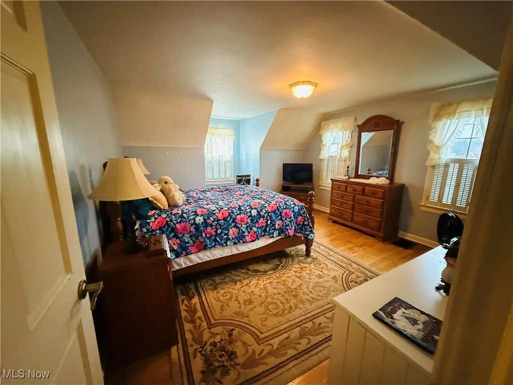 Bedroom with light wood-style flooring and baseboards