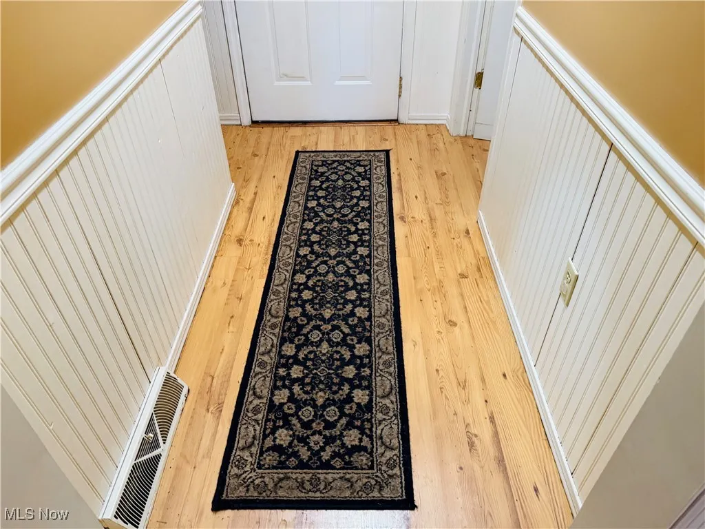 Doorway featuring light wood finished floors and visible vents