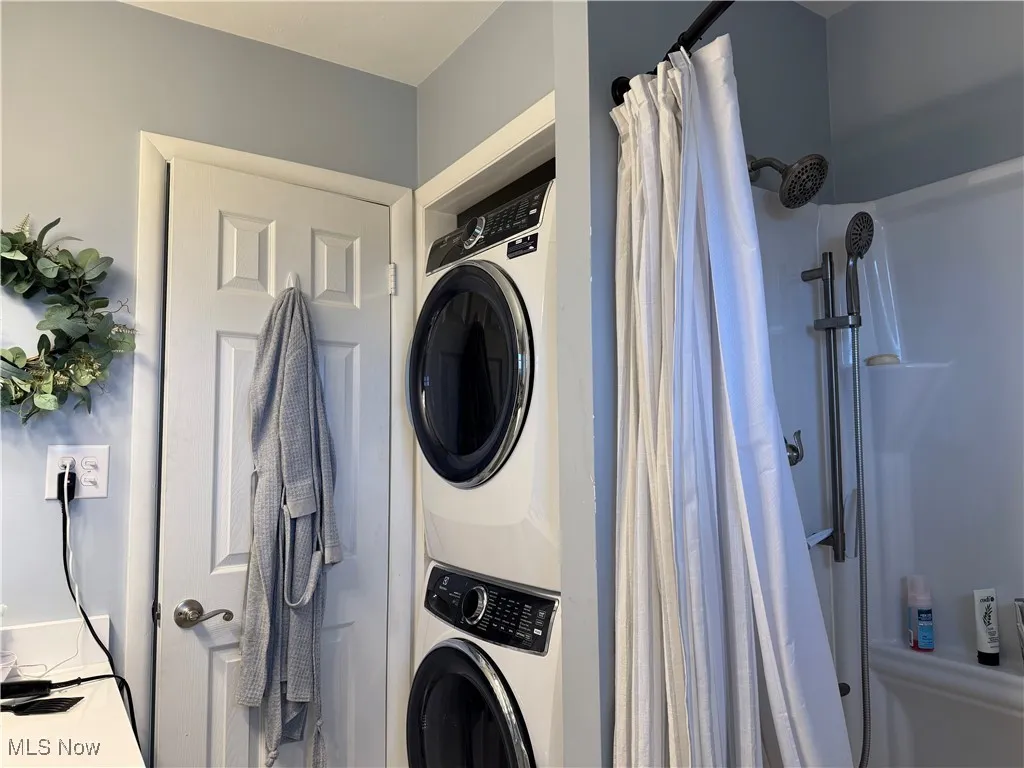 Clothes washing area with stacked washer / dryer and laundry area