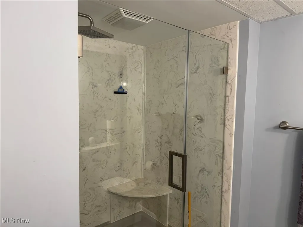 Bathroom featuring visible vents and a stall shower