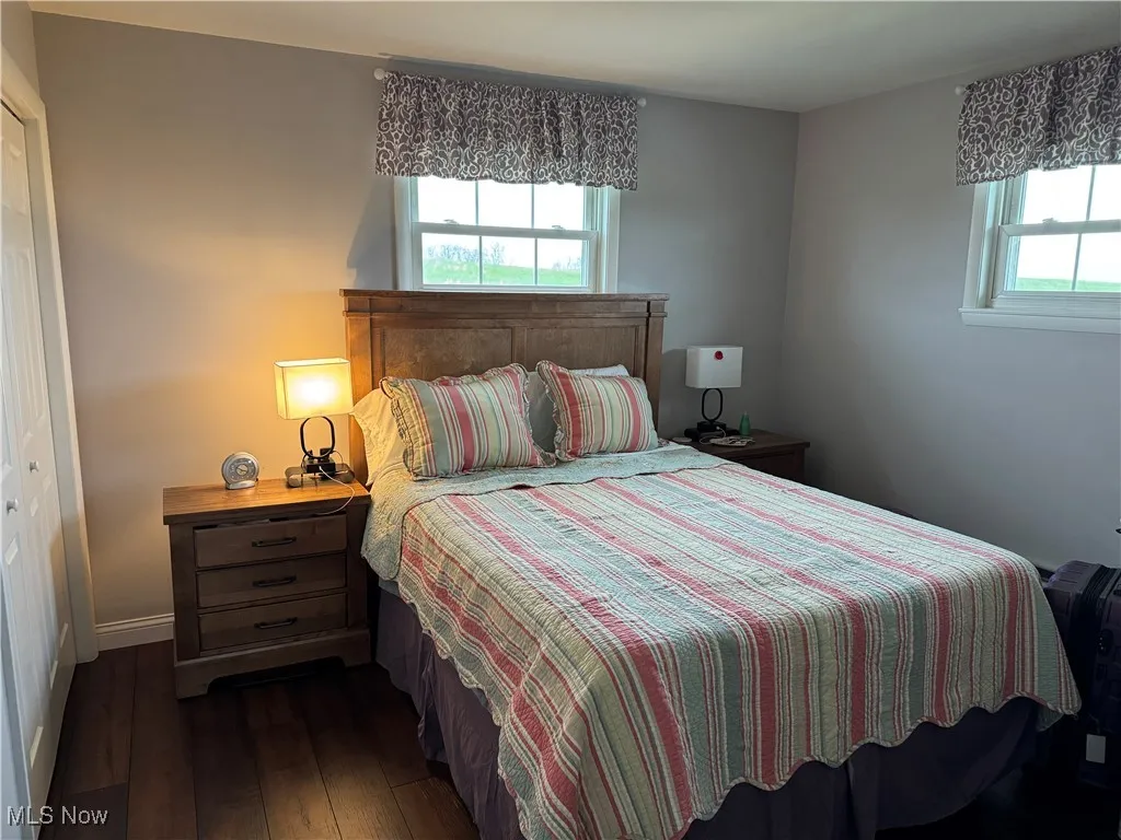 Bedroom with dark wood-type flooring and​​‌​​​​‌​​‌‌​‌‌​​​‌‌​‌​‌​‌​​​‌​​ baseboards