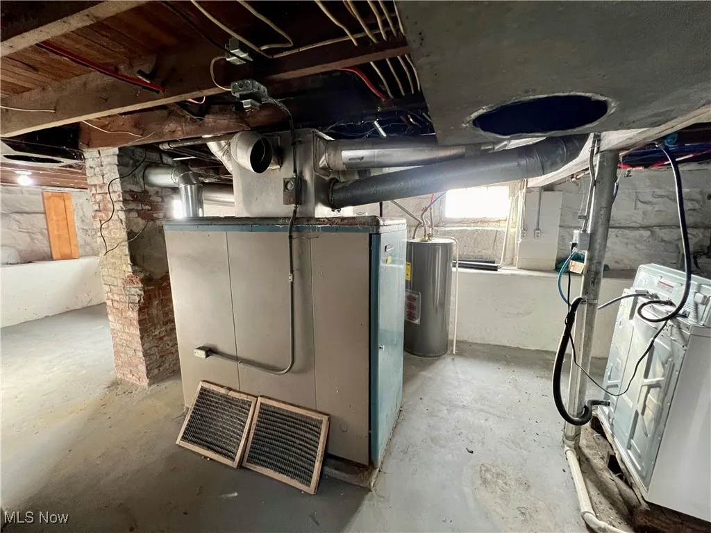 Below grade area featuring washer / clothes dryer and water heater
