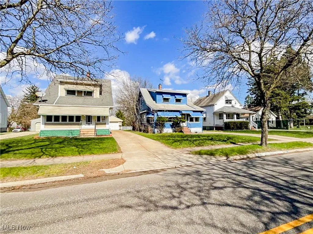 Bungalow-style home featuring a front yard, roof with shingles, and driveway