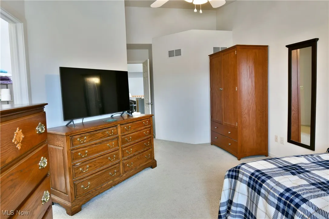 Bedroom with visible vents and light colored carpet