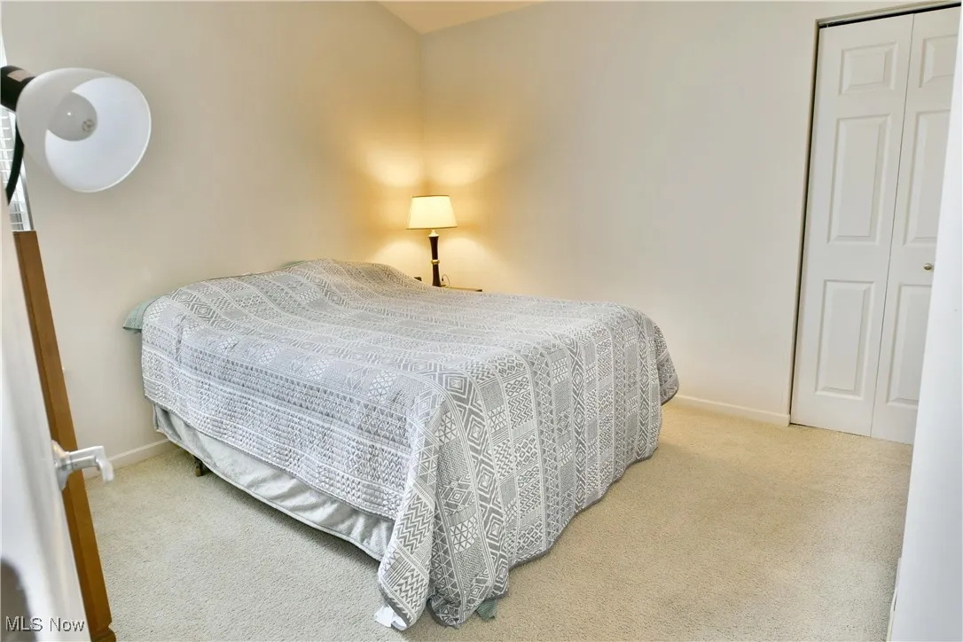 Carpeted bedroom featuring baseboards