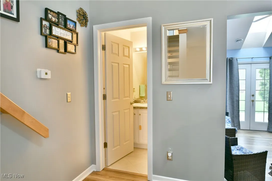 Corridor with baseboards and light wood finished floors