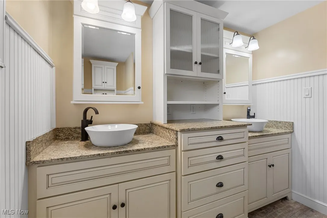 Bathroom featuring vanity and wood finished floors
