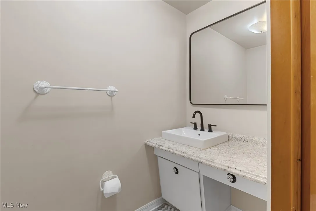 Bathroom featuring vanity and baseboards