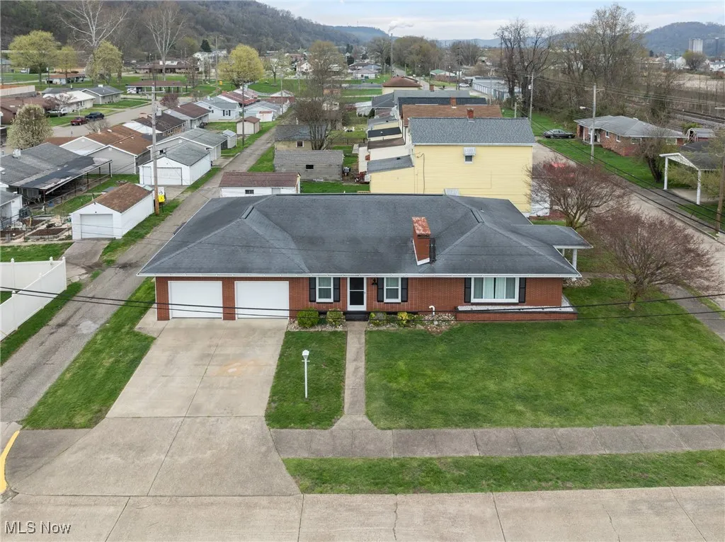 Birds eye view of property with a mountain view and a residential view