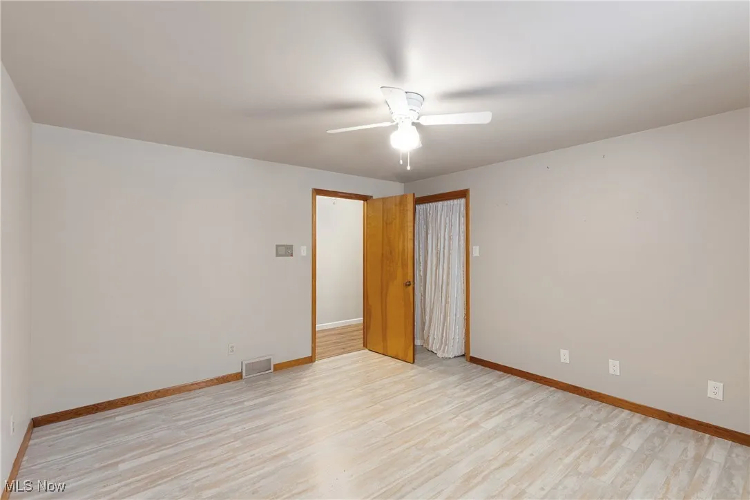 Unfurnished bedroom featuring light wood-type flooring, baseboards, and visible vents