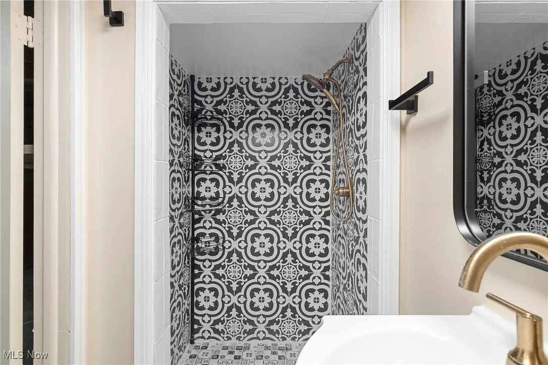 Full bathroom with tiled shower and a sink
