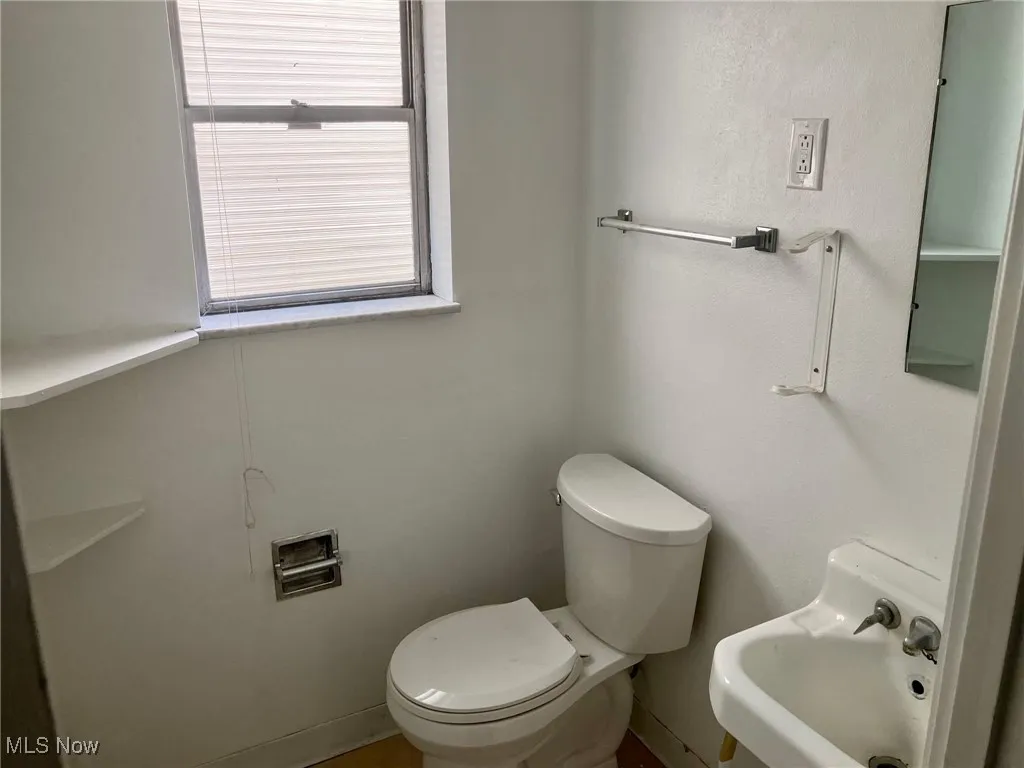 Half bath with toilet and a sink